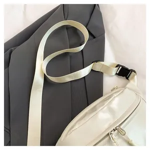 Close-up of white crossbody bag featuring lychee texture and woven shoulder strap