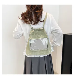 Light green backpack with pleated texture and a large transparent mesh pocket detail
