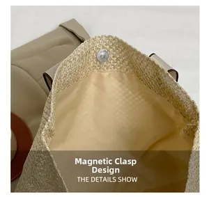 Close-up of magnetic snap closure and woven straw texture on large beige tote bag