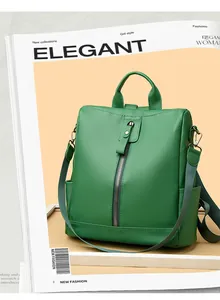 Detail of green textured backpack with vertical zipper, side pocket and fabric strap
