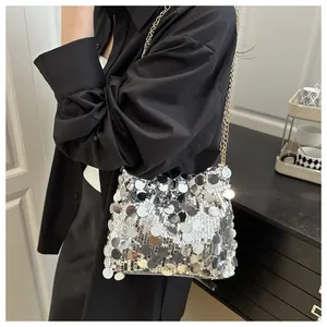 Close-up of silver sequin crossbody bag with metallic sheen and gold chain strap