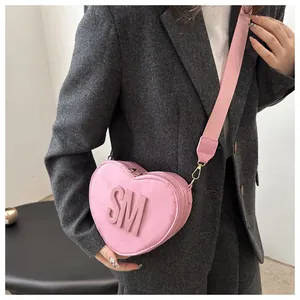 Close-up of pink heart-shaped bag with 3D SM letters and adjustable wide strap