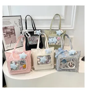 Detailed display of five colorful Ita bags with clear PVC windows and anime decorations
