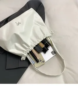 Interior view of white ruched tote bag showing ample space for iPad, phone and cosmetics