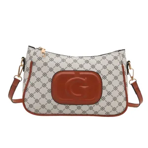 Minimalist cream shoulder bag with geometric chain patterns and embossed G logo plaque