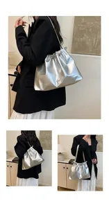 Detailed macro view of silver metallic pleated tote bag with drawstring and bow charm