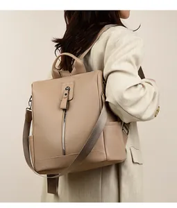 Side view of a khaki women's oxford backpack with adjustable wide fabric straps