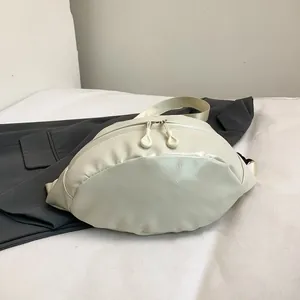 Detailed close-up of cream-colored textured PU leather waist bag with dual zippers