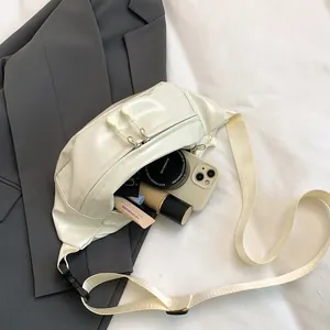 Detail view of cream white PU sports chest bag with wide strap and dual zippers