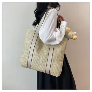 Interior view of large straw tote bag with canvas straps and yellow tulip accessories