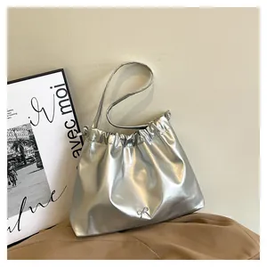 Detail of silver metallic drawstring tote with elegant silver bow decoration