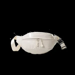Detail of cream sports waist bag featuring double zippers and durable nylon strap buckles