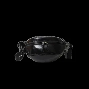 Detail view of black glossy PU leather waist bag featuring dual zippers and adjustable strap