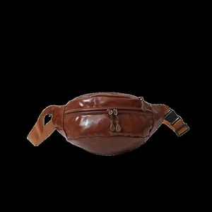 Close-up of brown glossy PU leather waist bag featuring double zippers and plastic buckle