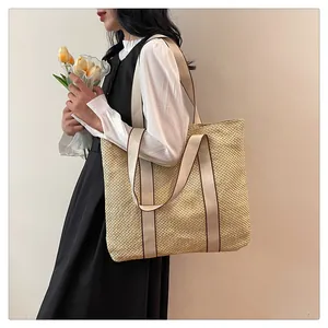 Detail shot of the sturdy canvas handles and textured woven surface of this tote bag