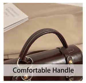 Detail view of the comfortable rounded handle and gold metal hardware on retro handbag