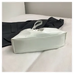 Detail showing the pleated soft white leather texture of the cloud-style tote shoulder bag