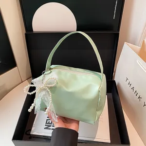 Minimalist mint green PU leather underarm bag with decorative pearl lace bow charm