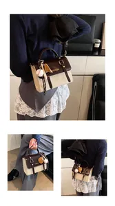 Close-up of retro British style crossbody bag featuring bicolor PU leather and fashion logo