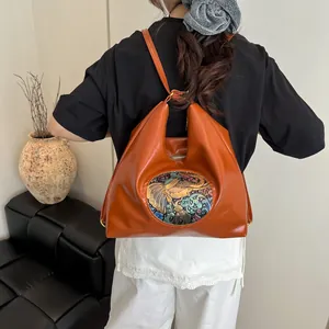 Versatile burnt orange leather backpack with vintage ethnic elephant embossed patch