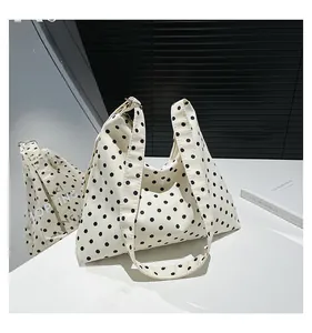 Dettaglio della borsa hobo a pois neri su tela bianca resistente con tracolla