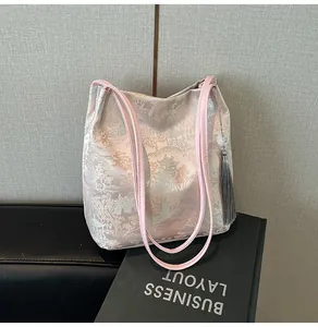 Close-up of Chinese style embroidery on tote bag with delicate silk tassel detail