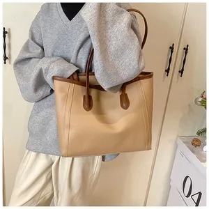 Close-up of a large lychee texture tote bag featuring brown trim and spacious design