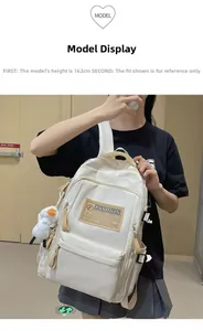 White minimalist backpack with fashion label and plush duck pendant shown on a 162cm model