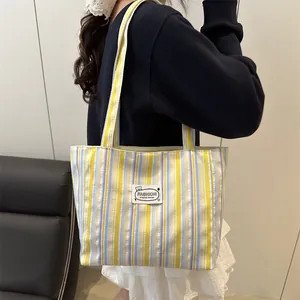 Striped canvas tote bag in yellow and blue with fashion patch for daily commuting