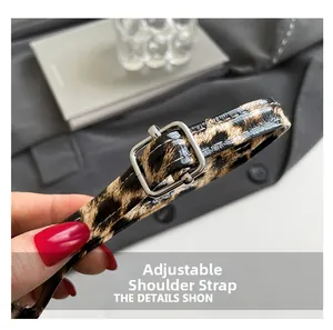 Detail of adjustable leopard print strap with a silver metal buckle and fine stitching