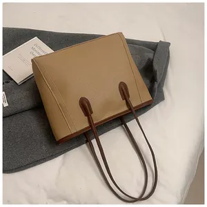 Detailed overhead view of a large capacity lychee grain tote bag on a wool coat