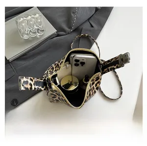 Detail showing the large interior capacity of this leopard print crossbody bag