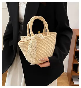 Détail du sac en coton tressé beige avec un élégant nœud décoratif en dentelle blanche