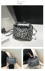 Detail of black leopard print pillow bag with glossy finish and silver metal hardware