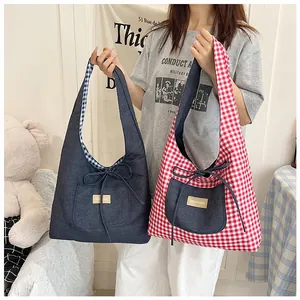 Detail of plaid tote bag with denim pockets, bow ties and Fashion & Bags fabric label