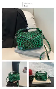 Detailed views of green leopard print pillow bag with shiny patent leather and silver hardware