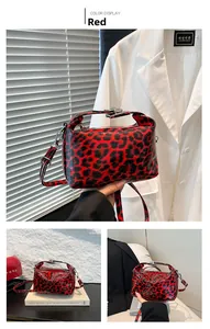 Detailed macro view of red leopard print glossy patent leather handbag with silver hardware