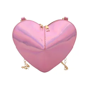 Pink holographic heart-shaped shoulder bag with metallic gold zippers and chain strap