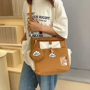 Canvas bucket bag in brown and white patchwork with multi-pockets and adjustable strap