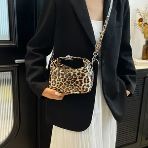Chic leopard print handbag with silver clasp and shoulder strap for spring 2025 fashion