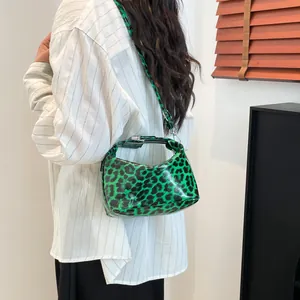 Vibrant green leopard print crossbody bag for women with silver hardware and adjustable strap
