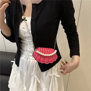 Pink shell-shaped mini crossbody bag with pearl chain and golden metal strap