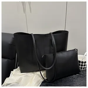 Minimalist black leather tote bag with matching zipper pouch insert for daily commute
