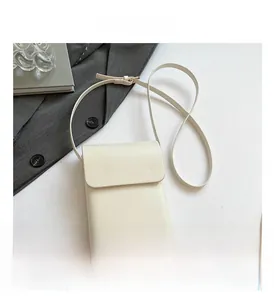 Detailed top view of a cream-white leather mobile phone crossbody bag with adjustable strap