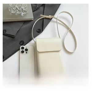 Vertical off-white leather phone bag with magnetic flap and adjustable strap detail