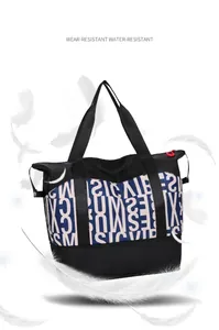Detail of lightweight waterproof nylon tote bag with blue letter print and floating feathers