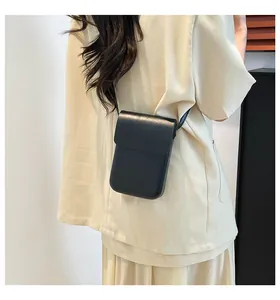 Minimalist black synthetic leather phone crossbody bag shown on a model back
