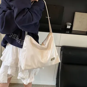 Chic off-white patent leather crossbody bag with metallic logo detail for women