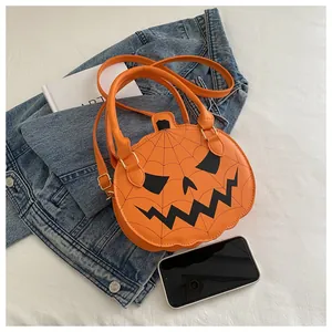 Detail of Halloween pumpkin shaped orange leather crossbody bag with Jack-O-Lantern face