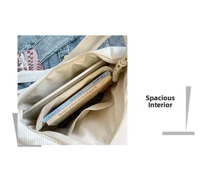 Macro view showing large capacity interior of white corduroy crossbody bag with zipper pocket